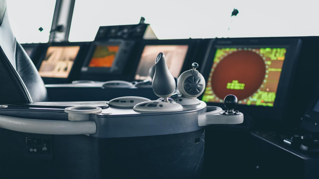 Close-up view of ship navigation controls and radar display screens on a vessel bridge