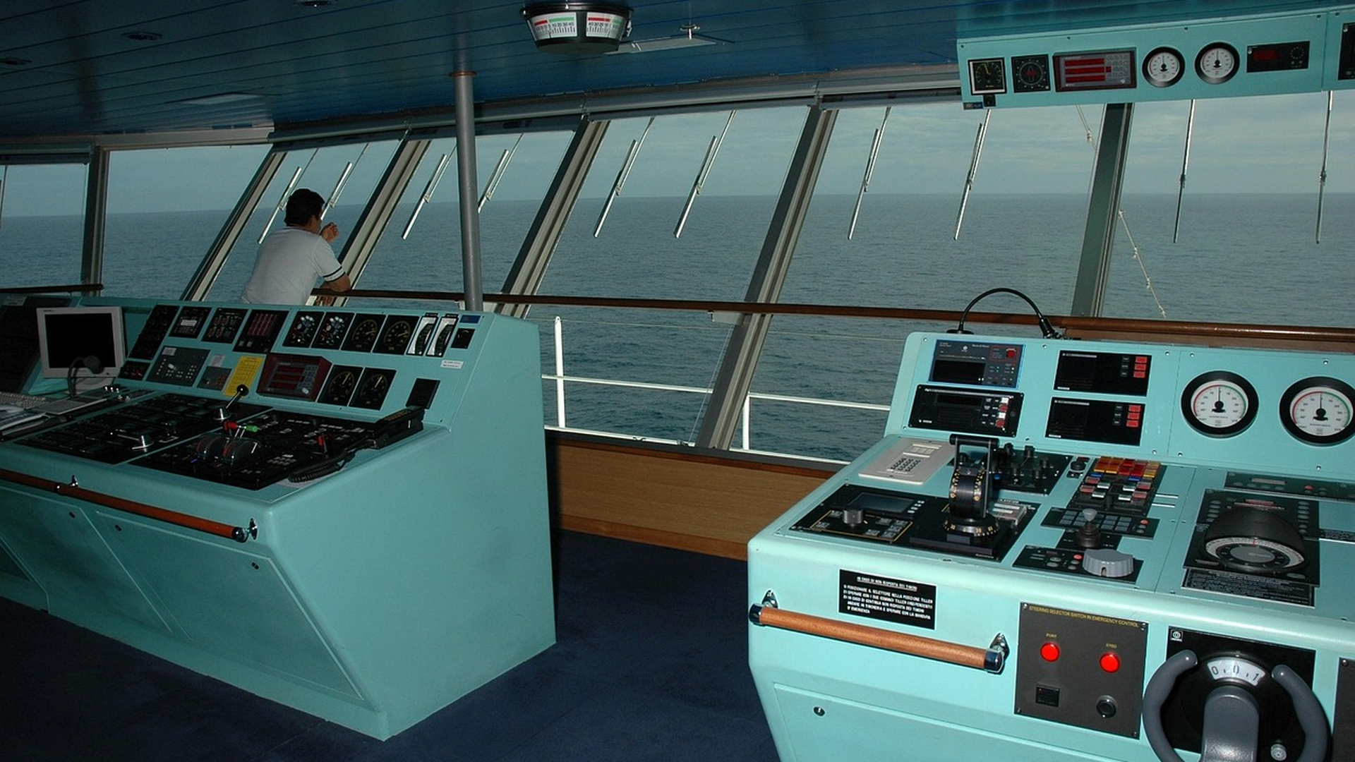 Ship bridge command deck with radar console and navigation instruments showing the marine traffic map view