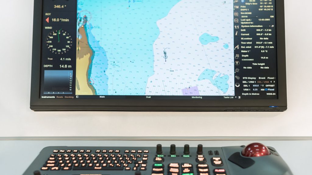 Rugged Laptops image by Seatronx Marine bridge navigational display with coastline chart, HDG/STW/COG/SOG readouts, and dedicated control keypad on a commercial shipping vessel.
