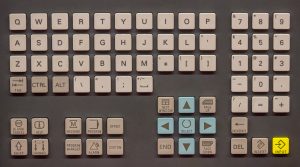 Close-up of a sealed industrial control-panel keyboard on an operator console, representing the sealing, key-material, and mounting decisions when speccing an industrial computer keyboard.