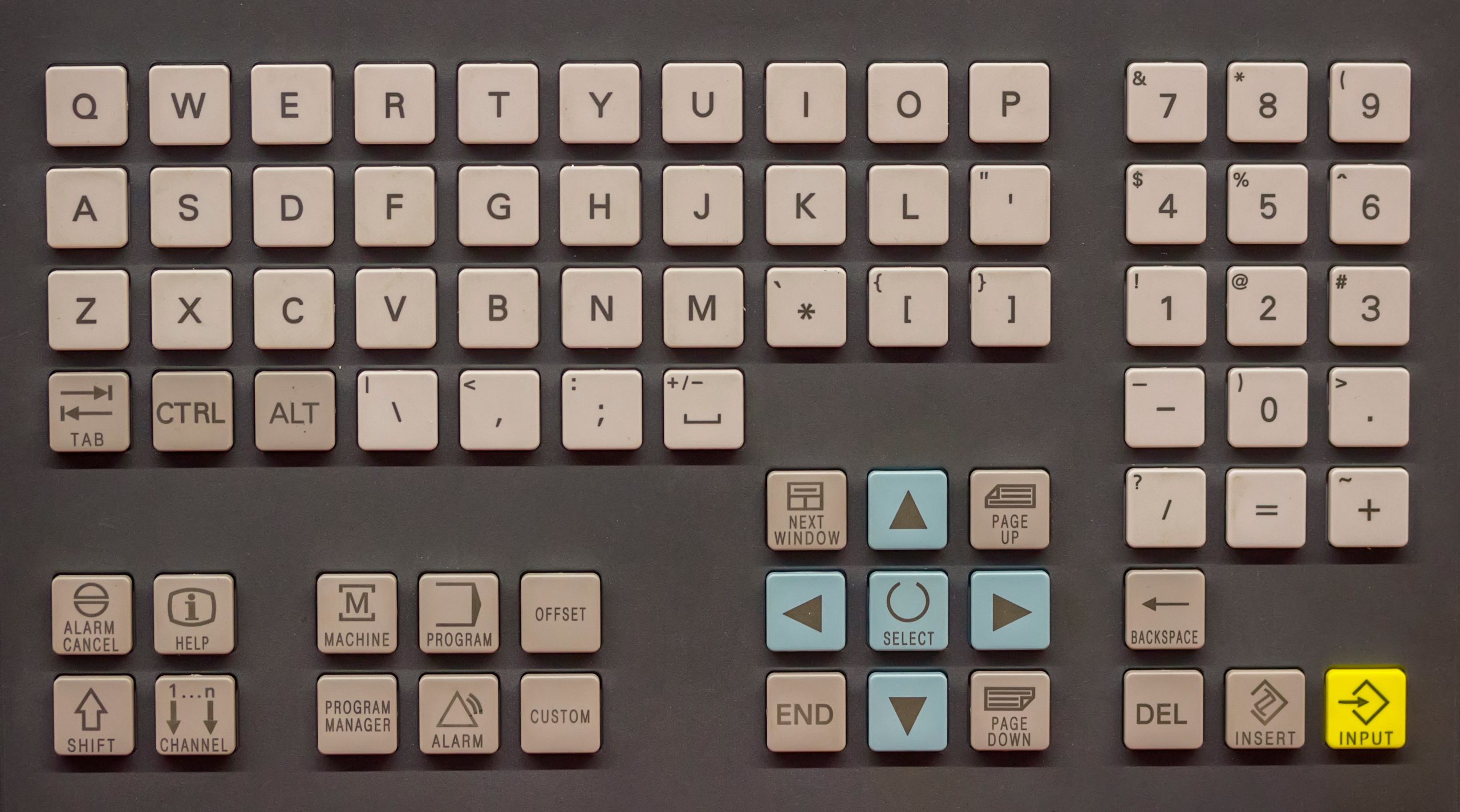 Close-up of a sealed industrial control-panel keyboard on an operator console, representing the sealing, key-material, and mounting decisions when speccing an industrial computer keyboard.