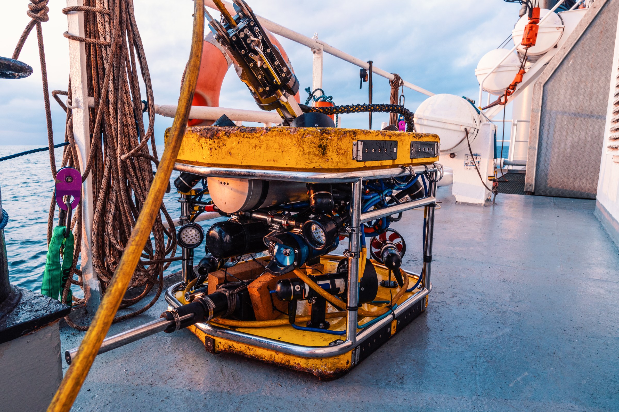 Inspection ROV with floodlights and camera housings on the after deck of an offshore support vessel