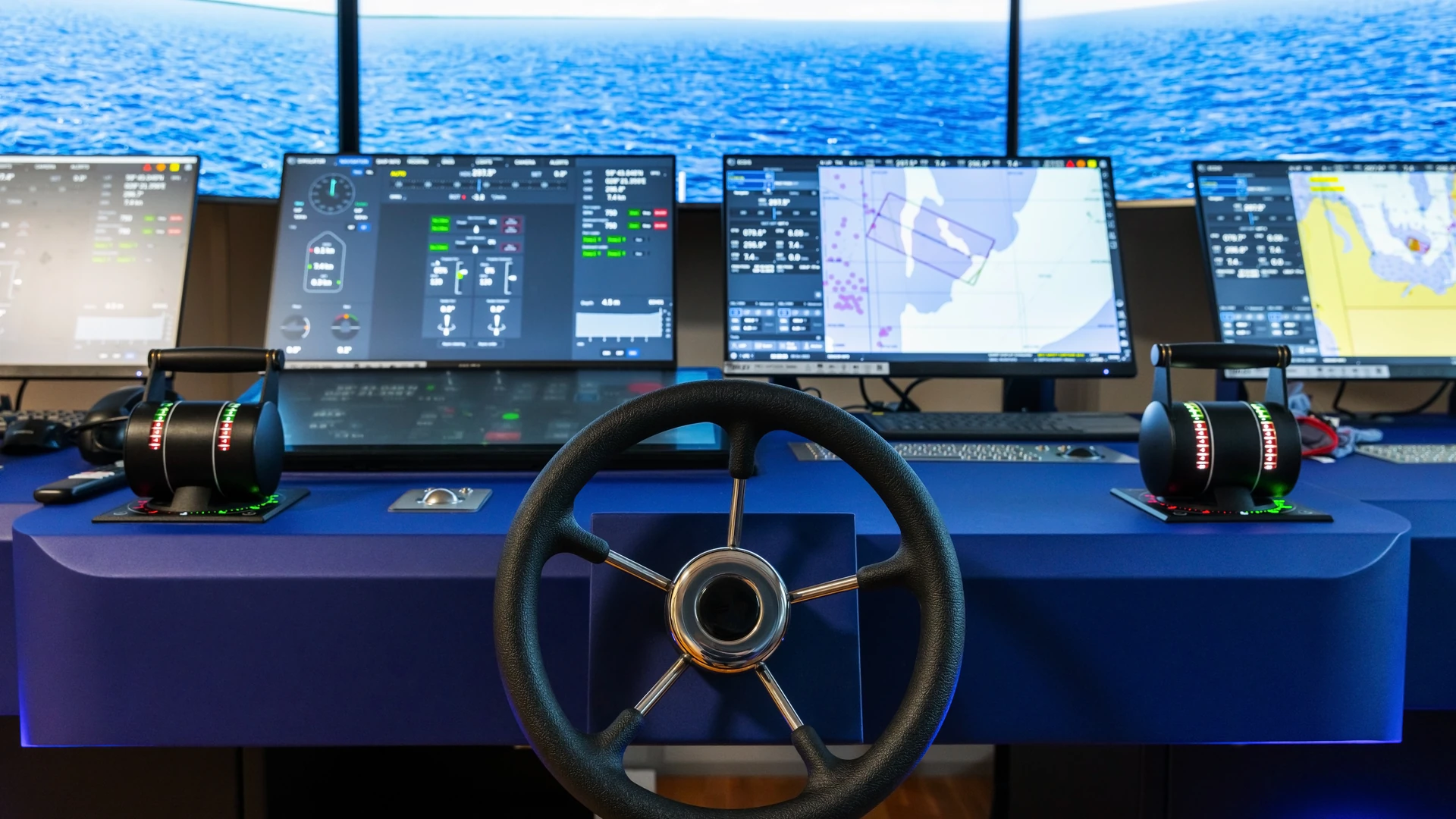 Bridge console with navigation screens, a steering wheel and paired engine controls